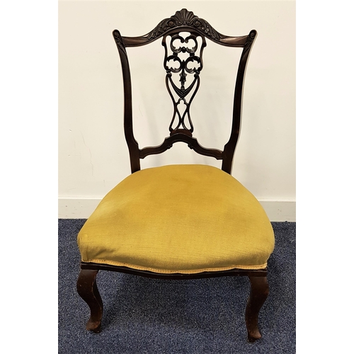 559 - MAHOGANY NURSING CHAIR
with a shaped top rail above a carved and pierced central splat with a stuffo... 