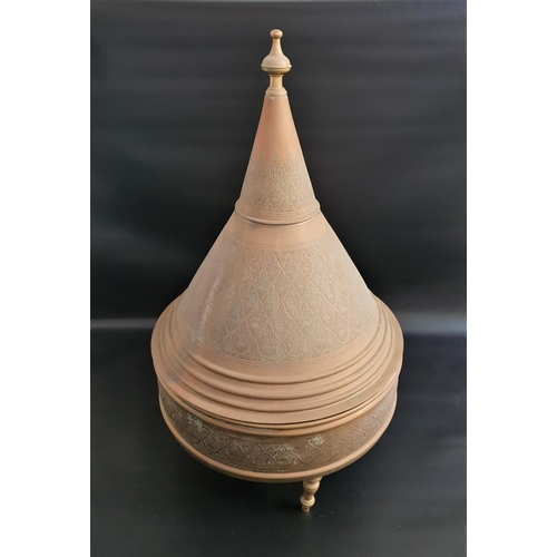 337 - LARGE BRASS TAGINE
the conical lid with embossed decoration, the circular base on three turned brass... 