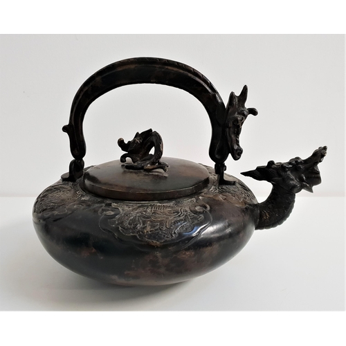 346 - CHINESE BRONZE KETTLE
of squat circular form, with a swing dragon handle, the body with a dragon spo... 