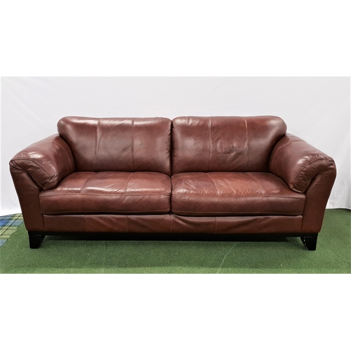 555 - LARGE BROWN LEATHER SOFA
with rollover arms, standing on stout shaped supports, 220cm long