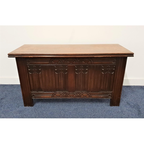 566 - OAK COFFER
with a lift up lid above a carved linen fold front panel, standing on plain supports, 98.... 