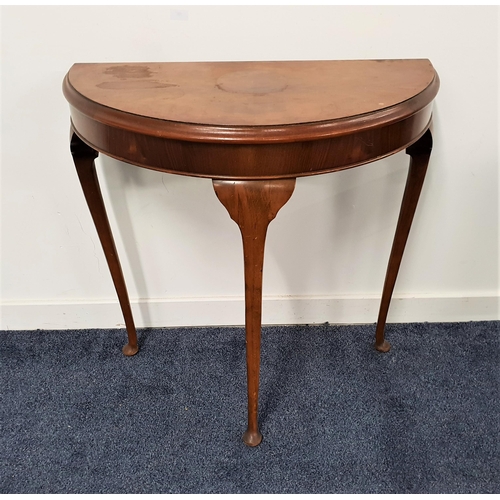 571 - WALNUT SIDE TABLE
with a D shaped moulded top, standing on three slender supports with pad feet, 76c... 