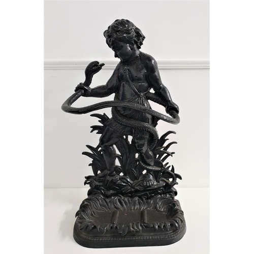 574 - CAST IRON STICK STAND
depicting Hercules with a serpent, with a removeable drip pan, 81cm high