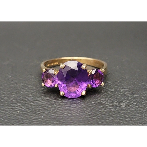 57 - GRADUATED AMETHYST THREE STONE RING
the central oval cut amethyst approximately 2.5cts flanked by ro... 