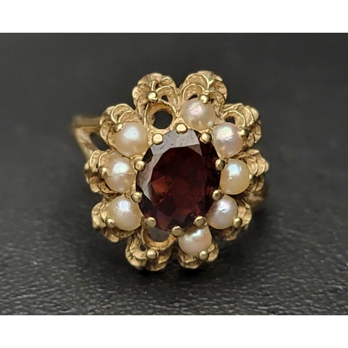 118 - GARNET AND SEED PEARL CLUSTER RING
the central oval cut garnet and seed pearl surround in pierced ba... 