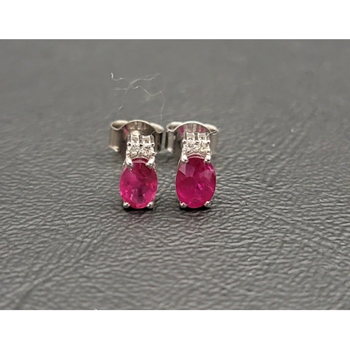 166 - PAIR OF RUBY AND DIAMOND STUD EARRINGS
the oval cut rubies totalling approximately 1.1cts and the di... 
