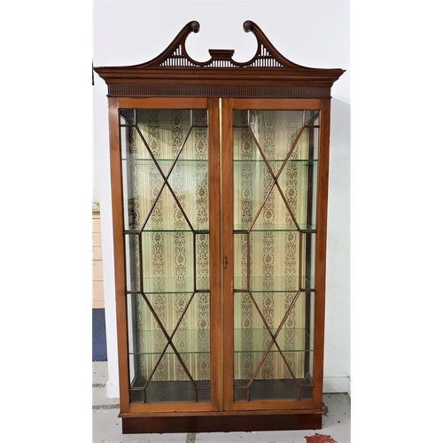 575 - MAHOGANY DISPLAY CABINET
with a carved swan neck pediment above a pair of astragal glazed doors and ... 