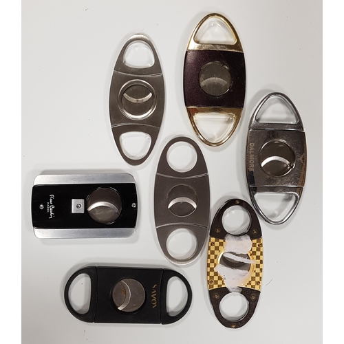 254 - SELECTION OF SEVEN CIGAR CUTTERS 
of various sizes and designs
Note: You must be over the age of 18 ... 