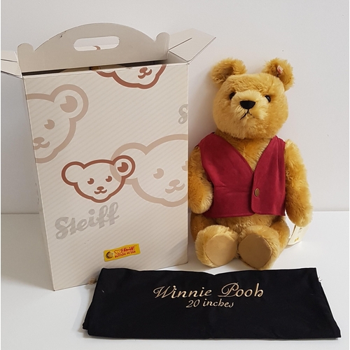 346 - STEIFF WINNIE THE POOH BEAR
with pouch and box, with button to ear and red and white tag, 51cm high