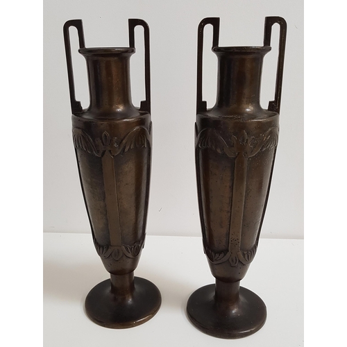 246 - PAIR OF BRONZE URNS
of slender amphora form, each with twin handles and decorative panels to the tap... 