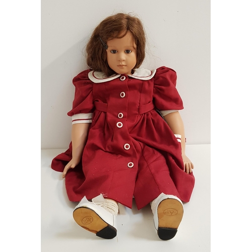 348 - RUTH TREFFEISEN DOLL
with a porcelain head, arms and legs, with long brown hair and wearing a burgun... 