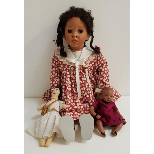 351 - JUST LYNDA BLACK DOLL
with porcelain head, arms and legs, with plaited hair, wearing a floral dress,... 