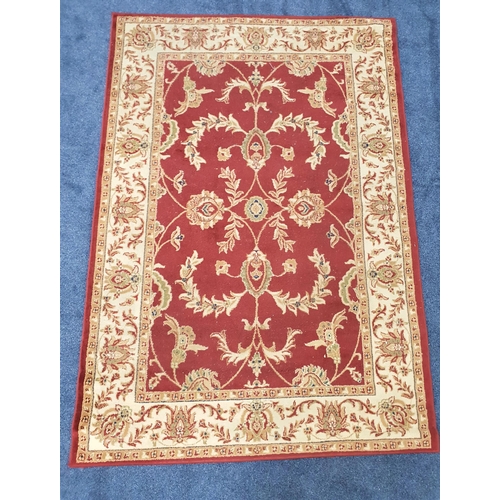 437 - LEGACY RUG
the claret ground with a floral design encased by a camel border with floral motifs, 230c... 