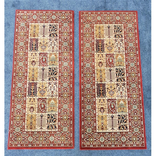 439 - TWO VALBY RUTA RUGS
each with a claret ground and floral border around twenty one panels, 180cm x 80... 