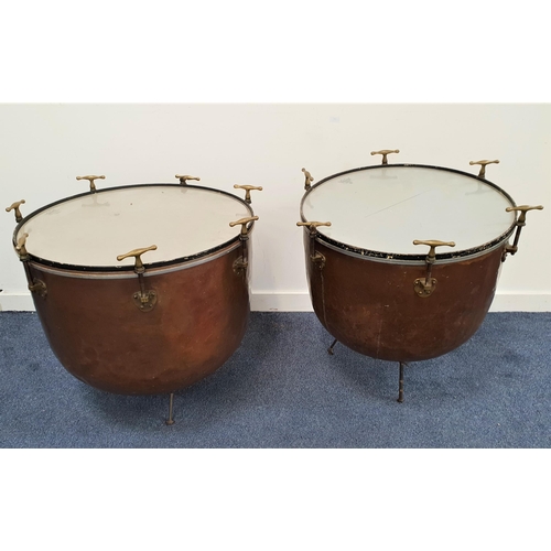 314 - PAIR OF HAWKES & CO COPPER TIMPANI 
each raised on three adjustable legs, the bodies marked 'Hawkes ... 