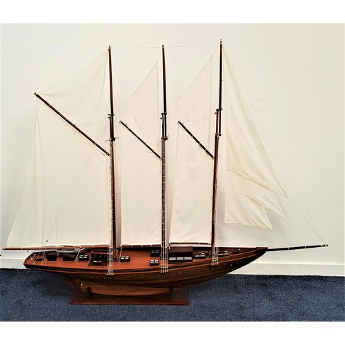 256 - SCALE MODEL OF A SCHOONER
with three masts and rigging, of teak construction with stand, 201cm long