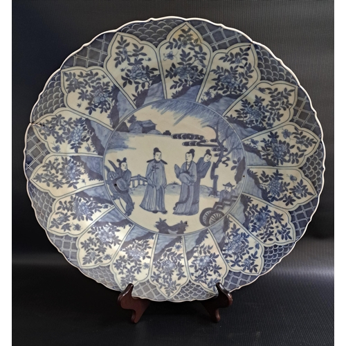 225 - 19th CENTURY CHINESE BLUE AND WHITE CHARGER
decorated with five figures in a garden, the border with... 