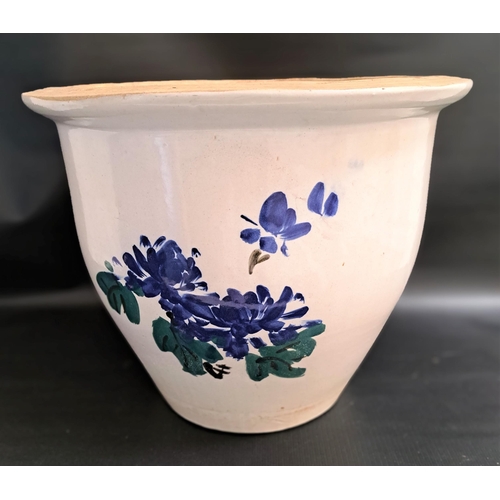 233 - LARGE TERRACOTTA PLANT POT
the white glazed body decorated with blue flowers, 40.5cm high