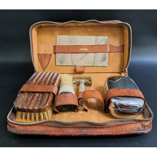 297 - GENTS TRAVELLING LEATHER TOILET BAG
with zip closure, opening to reveal a mirror, soap dish, razor, ... 