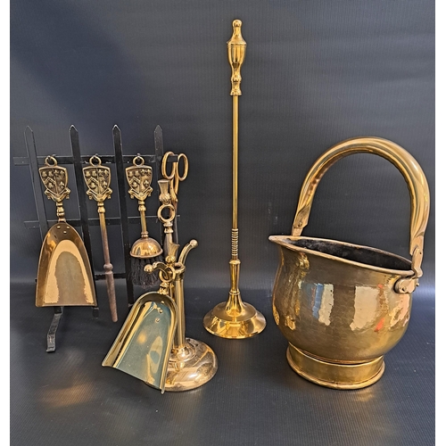 299 - SELECTION OF BRASS FIRE TOOLS
including a helmet shaped coal scuttle, squat fire poker and shovel wi... 