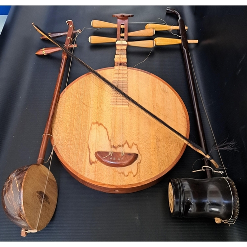 319 - SELECTION OF MUSICAL INSTRUMENTS
comprising a Chinese yueqin moon lute, Chinese erhu and a Thai saw ... 