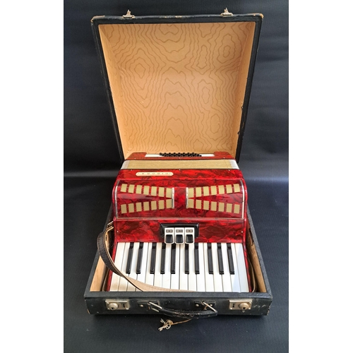 321 - DIBORA ACCORDIAN 
with a mottled red body in a fitted case