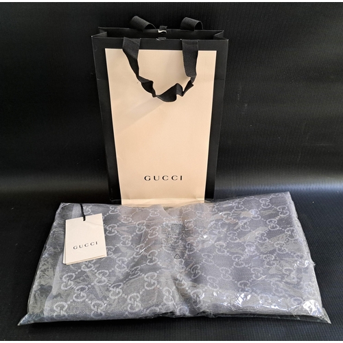 310 - NEW GUCCI GG GREY SCARF
80% wool and 20% silk, 140 X 140cm, in original packaging and Gucci bag with... 