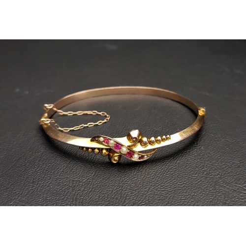 168 - EDWARDIAN SEED PEARL AND RED GEM SET BANGLE
the hinged bangle with safety chain, Birmingham hallmark... 