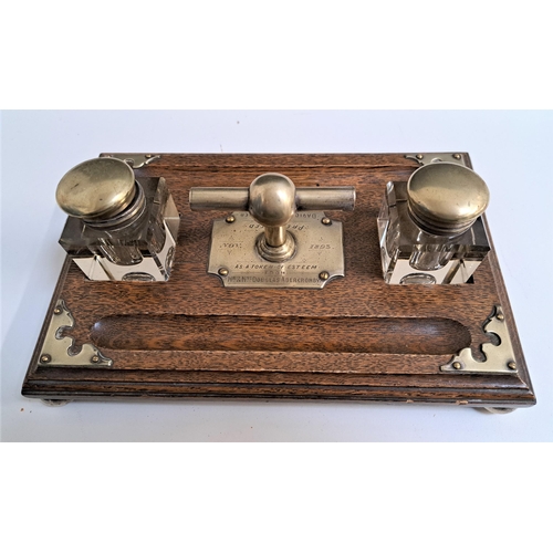 259 - VICTORIAN OAK DESK SET
with two glass inkwells and pen troughs with a central engraved presentation ... 