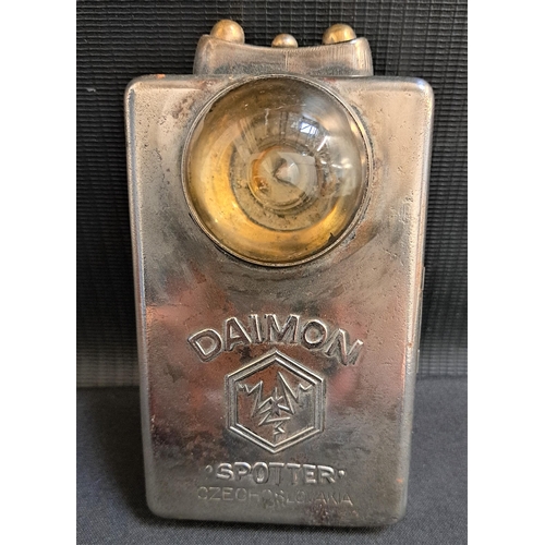 WWII DAIMON TUNIC TORCH
in a bright steel case with leather tab to rear, 12cm high