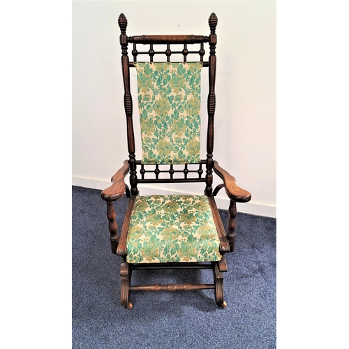 477 - AMERICAN STYLE OAK ROCKING CHAIR
with a part padded back and seat, on shaped rockers with front cast... 