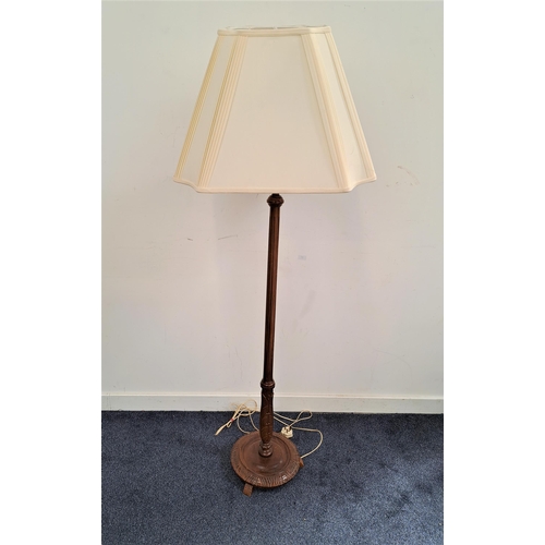 488 - MAHOGANY STANDARD LAMP
raised on a circular carved base with a fluted column and a cream shaped shad... 