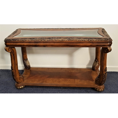 469 - WALNUT CONSOLE TABLE
with a shaped inset glass top and scroll carved borders, on scroll supports wit... 