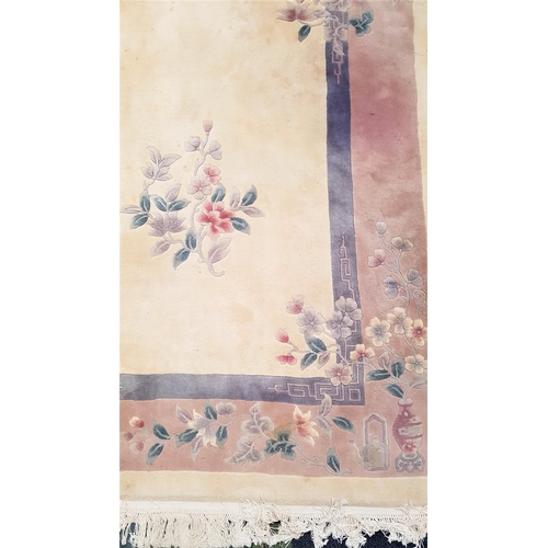 478 - LARGE CHINESE WASH RUG
with a cream ground encased in a pale blue and mauve border with floral motif... 