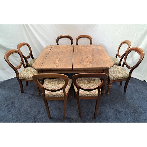 425 - EDWARDIAN OAK DINING TABLE AND SET OF VICTORIAN CHAIRS
the table with canted corners and a wind out ... 