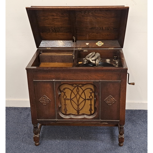 322 - 1930s GILBERT GRAMOPHONE
in an oak case with a lift up lid above a sliding door opening to reveal a ... 