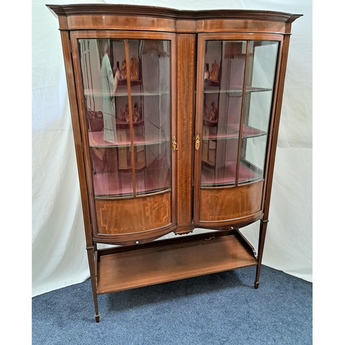 EDWARDIAN MAHOGANY AND CROSSBANDED DOUBLE BOW FRONT DISPLAY CABINET
the doors and glass side panels enclosing shelves and retailers label Charles Jenner & Co, Princes Street, Edinburgh, standing on tapering supports with spade feet united by an undertier, 177cm x 122cm