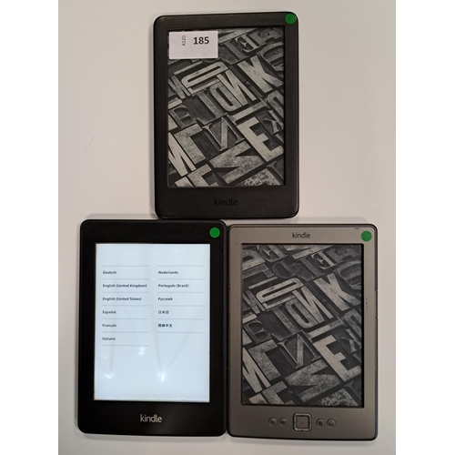 185 - THREE AMAZON KINDLE E-READERS
comprising a Basic 3, serial number G090 VB06 1222 06JV; a Kindle 4 No... 