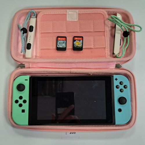 203 - NINTENDO SWITCH 
S/N XKN50065357670, with two games comprising Pokemon Lets Go Pikachu and Pokemon L... 