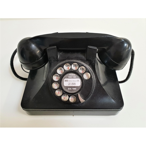 169 - VINTAGE BAKELITE TELEPHONE
with a rotary dial and handset, with current socket fixing