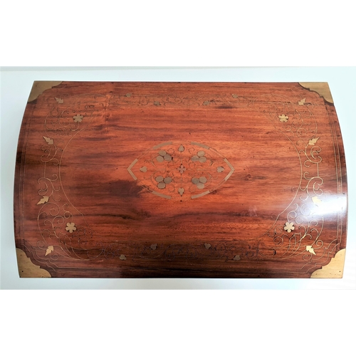 187 - TEAK CASKET
with floral brass inlay and side handles with a domed lid opening to reveal a lift out t... 