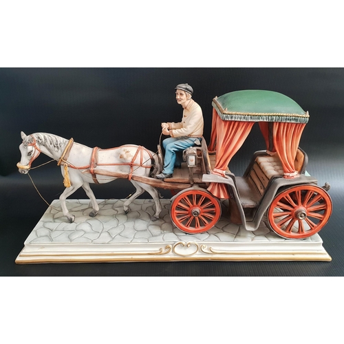 148 - CAPODIMONTE PORCELAIN FIGURE GROUP
of a horse and carriage on a cobbled street, 44cm long