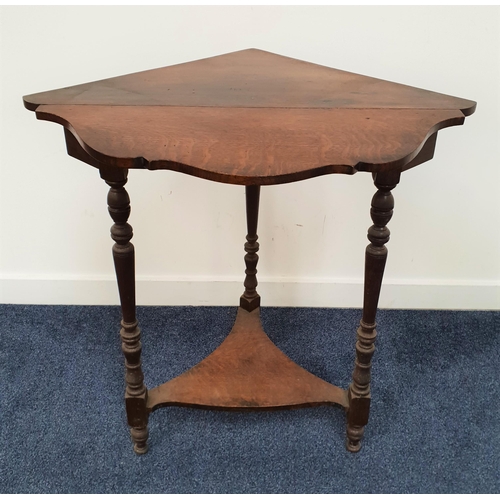 382 - OAK CORNER TABLE
with a singular shaped drop flap standing on turned supports united by a shaped und... 