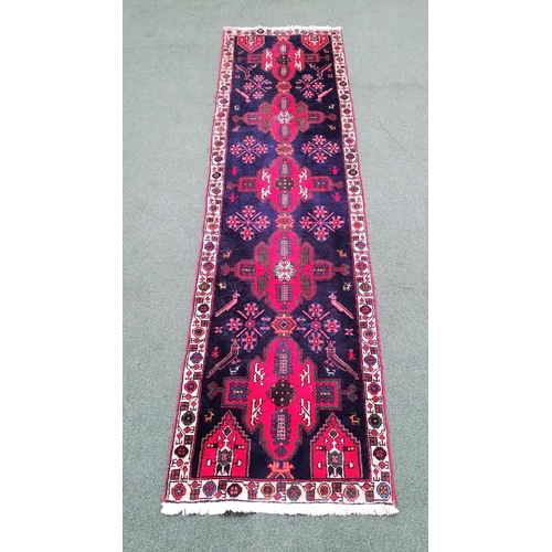 404 - ZAGHEH RUNNER RUG
with a deep inky blue ground with red lozenge motifs, 287cm x 79cm