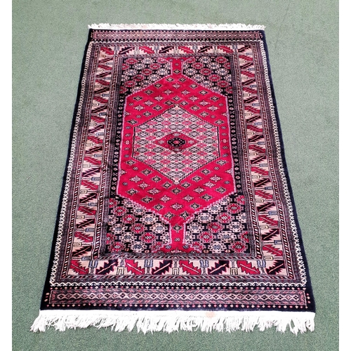 406 - QASHQAI RUG
with a blue and red ground with a central lozenge, 192cm x 127cm