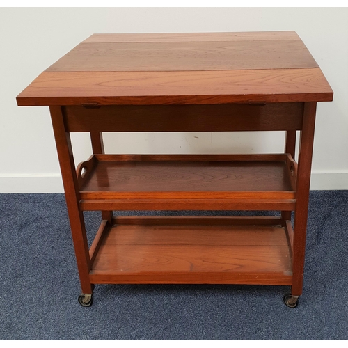 425 - TEAK TROLLEY
the rectangular top with drop flaps above a frieze drawer, with a removeable tray below... 