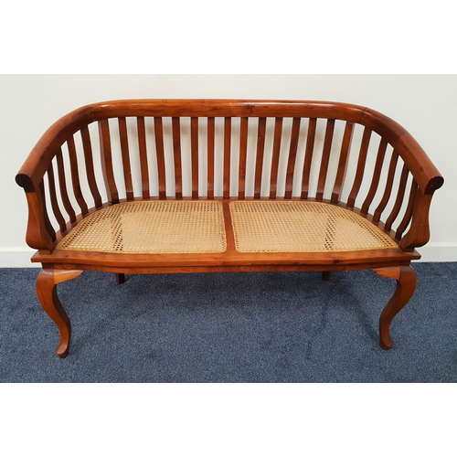 430 - TEAK BENCH
with a shaped slatted back above a caned seat, standing on on cabriole front supports, 11... 