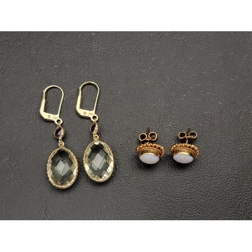 63 - TWO PAIRS OF NINE CARAT GOLD MOUNTED EARRINGS
comprising a pair of gem set drop earrings with light ... 