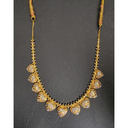 112 - TWENTY-TWO CARAT GOLD NECKLACE
the two-tone hanging hearts on a box chain with beaded accents, appro... 