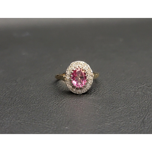 113 - PINK TOPAZ AND DIAMOND CLUSTER RING
the central oval cut topaz approximately 0.75cts in a sixteen di... 